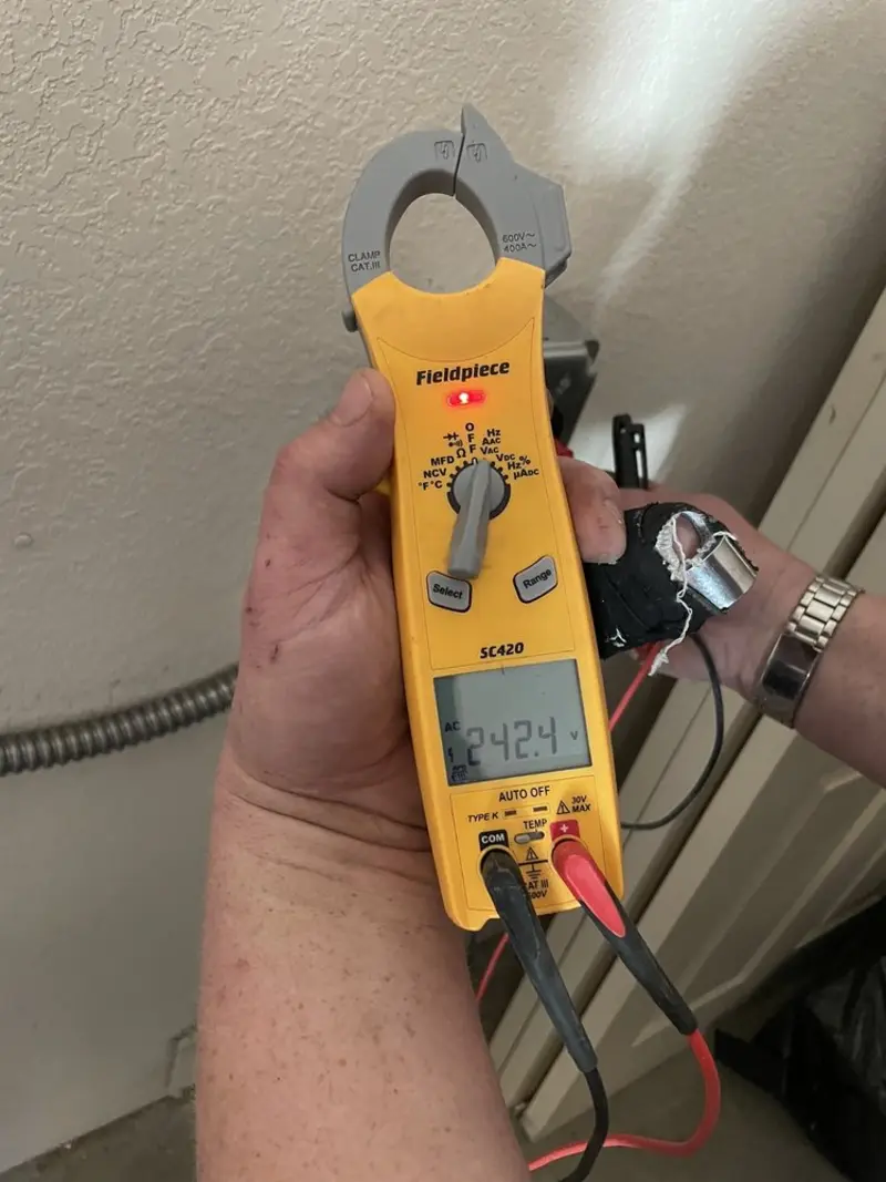 Voltage testing with clamp meter during Electrical Installation Services in Livingston